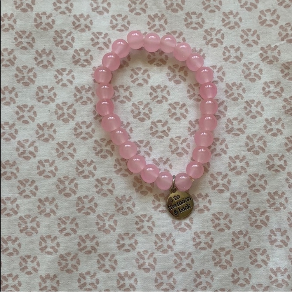 Pretty pink bracelet with silver charm.